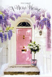 A charming Aldgate doorway is captured here as if paused at the very moment a new life begins inside. The focal point is a pale pink front door, softly luminous against its whitewashed surroundings, the kind of shade you might spot on a quiet residential turning off Aldgate High Street. The door is flanked by a delicately coloured shutter, slightly ajar, inviting light to spill across the entrance. Above, mature wisteria drapes in abundant lavender streams, each flower cluster hanging like a tassel in a gentle, fragrant cascade. The branches weave a loose canopy that frames the door in a romantic sweep of colour and texture. Resting at the threshold is a florist's grey bucket, solid and unpretentious, overflowing with creamy white roses that look freshly opened, their petals curling outward in plush, layered spirals. Wispy green foliage is threaded among the blooms, adding movement and a hint of garden wildness. Around the bucket, a soft pink ribbon has been tied in a graceful bow, its hue echoing the door and bringing a sense of intentional design to the scene. Gentle shadows suggest filtered daylight, perhaps from trees lining a nearby courtyard or square. There is no visible signage or clutter, only this thoughtful floral gesture waiting quietly on the step, as if left by a local Aldgate florist to surprise someone returning with the keys to their first home. The mood is calm yet expectant, a perfect visual companion to a card celebrating new home joys, fresh starts, and the feeling of finally being able to say, this is mine.